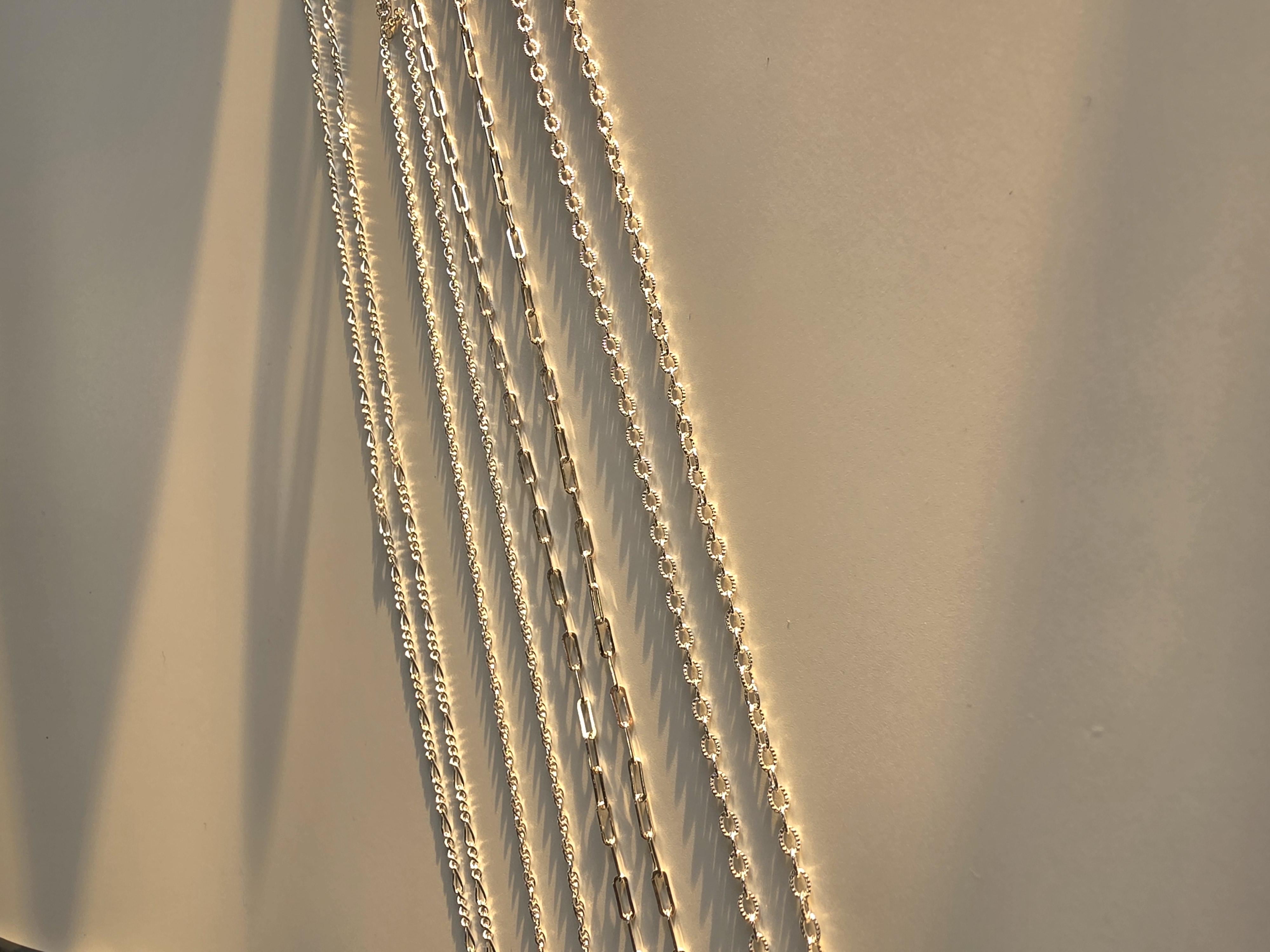 Permanent jewellery - piece, silver chains in low light