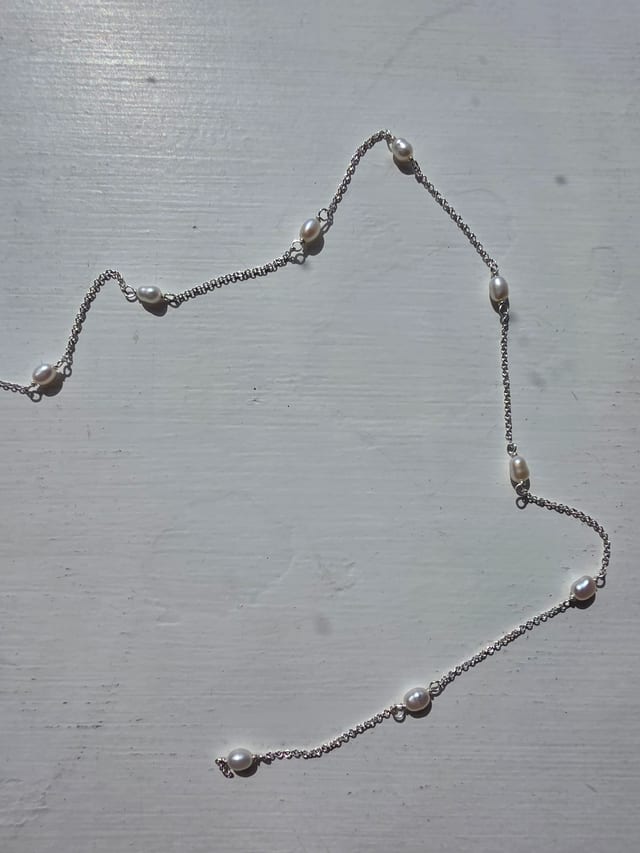 Permanent jewellery - piece, pearl chain on white background